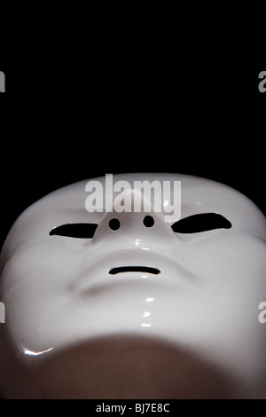 White mask on black background, man faces Stock Photo
