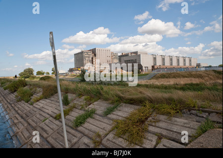 River wall and nuclear power station at Bradwell-on-Sea, Essex Stock Photo