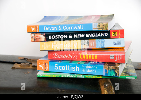 A selection of travel guide books on an old suitcase Stock Photo