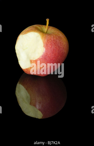 Close Up Image of a Gala Apple on a Black Reflective Background, with a Bite Taken From It. Stock Photo