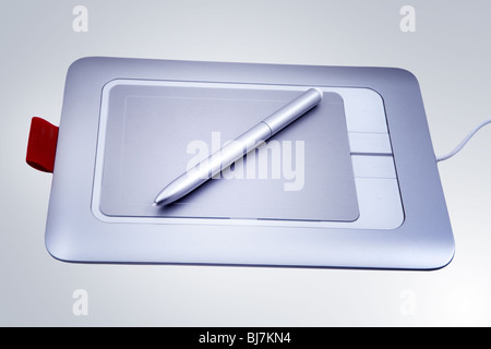 Electronic drawing pen tablet isolated on blue background Stock Photo