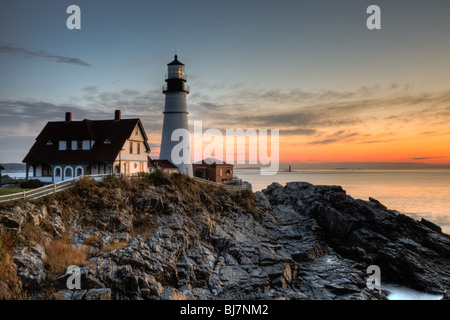 Portland Head Light, which protects mariners entering Casco Bay, at dawn.  The lighthouse is in Cape Elizabeth, Maine. Stock Photo