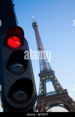 Red french traffic light / signal in Paris, with the Eiffel Tower behind. France.