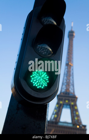Green french traffic light / signal in Paris, with the Eiffel Tower behind. France.