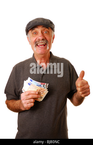 Older citizen holding a handful of Euros and giving the thumbs up Stock Photo