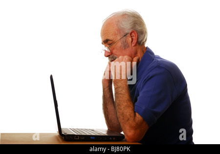 Senior Confused Using Computer Confused senior citizen using a computer, he is staring at the screen ...