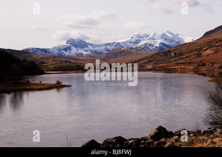 View from Capel Curig, over Llynnau Mymbyr towards snow capped peaks of Mount Snowdon, Wales Stock Photo