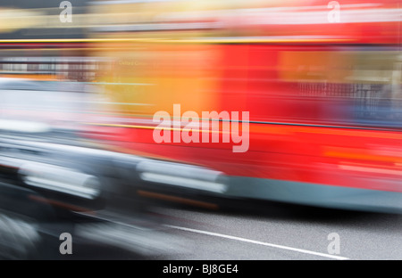 Taxi and Red Double Decker Bus Driving Down Street in London, Blurred Motion, transportation transport black red city traffic Stock Photo