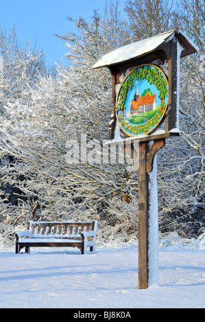 Winter wonderland village green and sign Stock Photo