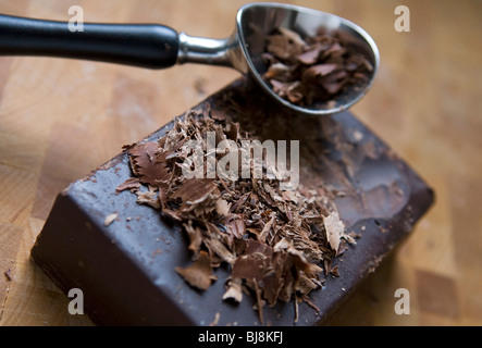 A block of dark chocolate and dark chocolate shavings.  Stock Photo
