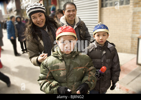 2010: Chinese New Year, Chinatown, NYC, Year of the Tiger. Chinese American family celebrating Chinese New Year . Stock Photo