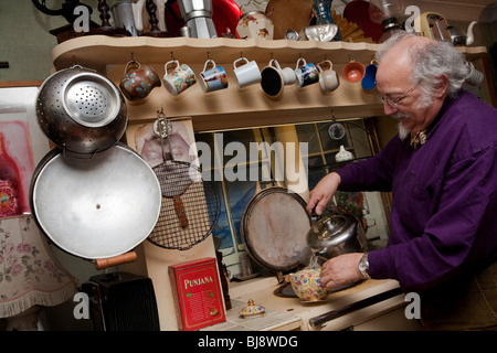 Senior man preparing pot of tea in his kitchen Stock Photo