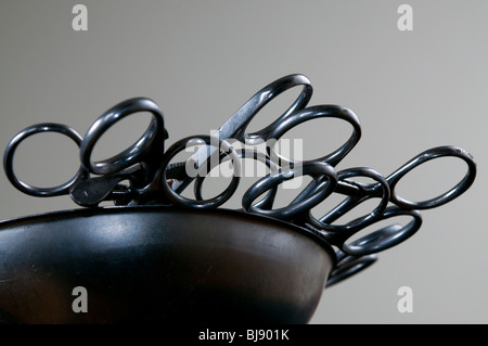 Forceps in a stainless steel kidney dish used in embalming and surgery Stock Photo