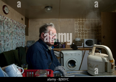 Senior single man watching a kettle boil in his motor home Stock Photo