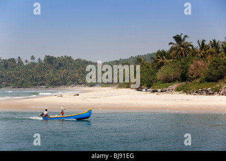 India, Kerala, Mahe (Pondicherry) Union Territory, man in outboard motor powered dugout canoe on estuary Stock Photo