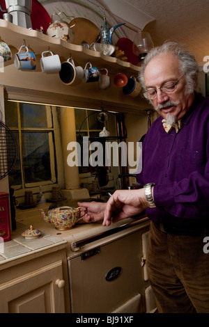 Senior man preparing pot of tea in his kitchen Stock Photo