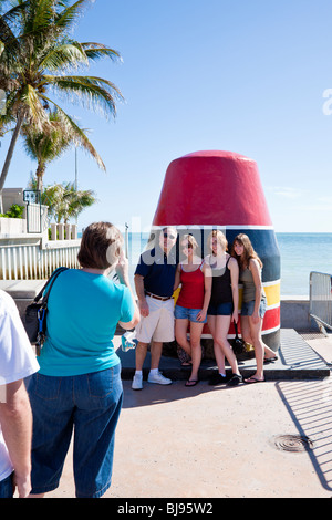 Key West, FL - Dec 2008 - Woman takes photo of family in front of Southernmost Point Buoy in Key West, Florida Stock Photo