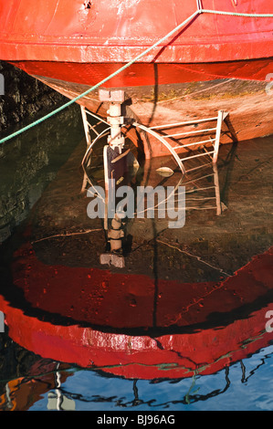 dh  STROMNESS ORKNEY Fishingboats rudder system reflection in harbour Stock Photo