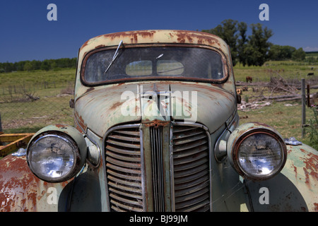 old vintage historic car with chrome aeroplane hood ornament in a field in Colonia Del Sacramento Uruguay South America Stock Photo