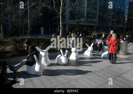 people sitting on rabbit sculptures in spitalfields, london Stock Photo ...