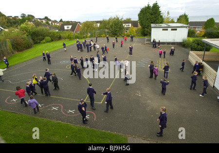 Traditional playground games being played on the school playground of a primary school in Wales UK Stock Photo