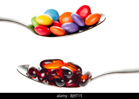 spoonful of pills and sweets Stock Photo