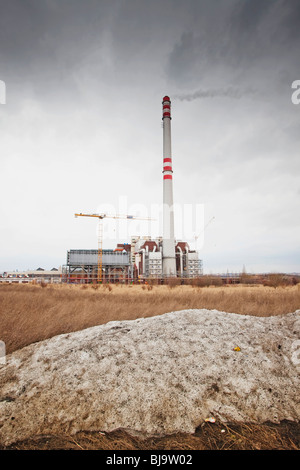 Smokestacks at an industrial waste-to-energy plant against a cloudy sky. Stock Photo