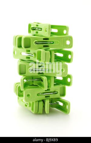 Plastic clothes pegs tower on white background Stock Photo