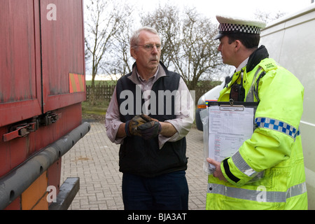 A Police Officer talking To A Lorry Driver Stock Photo