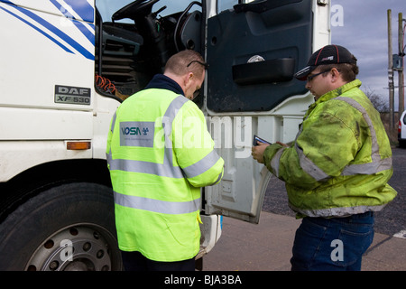 A VOSA Officer talking To A Lorry Driver Stock Photo