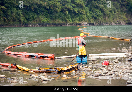 Oil spill in an Amazonian river with boom in position to contain slick. Stock Photo