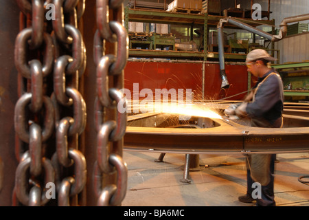 Man grinding a ropeway wheel in a factory of the Leitner Group, Italy Stock Photo