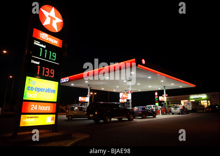 Texaco garage and CO-OP convenience store at night, UK Stock Photo