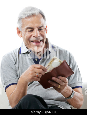 Old man taking out money from his wallet Stock Photo