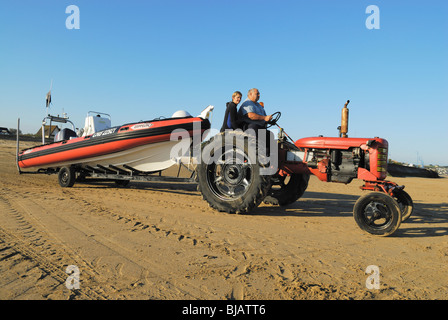 Farm tractor pulling an inflatable diving boat, Normandy, France Stock Photo