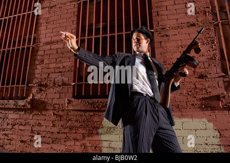 Gangster in dark pinstripe suit with Tommy gun Stock Photo