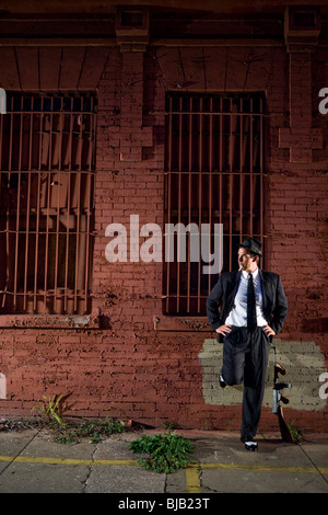 Gangster in dark pinstripe suit with Tommy gun Stock Photo