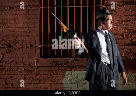 Gangster in dark pinstripe suit with Tommy gun Stock Photo