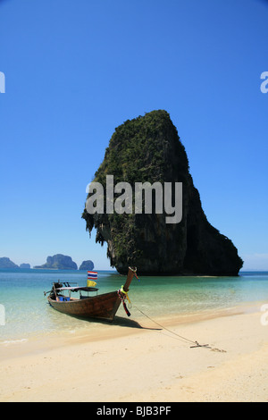 traditional wooden long tail boat on tropical Phra Nang beach by happy Island, Thailand Stock Photo