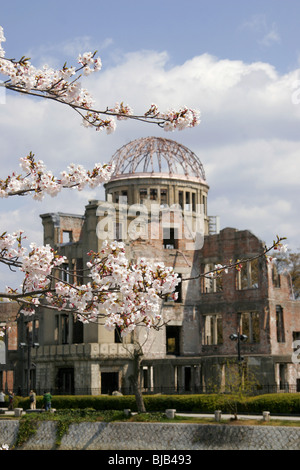 The A bomb dome, Hiroshima, Japan with cherry blossom in the foreground Stock Photo