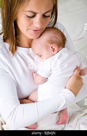 Close-up of mom gently hugging baby Stock Photo - Alamy