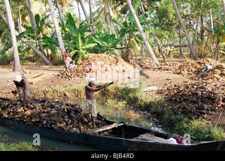 Coir Processing Small Industry.Raw Material coconut Husk is collected and transport through backwaters of Kerala to the Industry Stock Photo