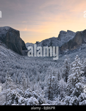 Tunnel View sunrise vista of El Capitan Half Dome Cathedral Spires and Bridalveil Fall after a snow storm Stock Photo