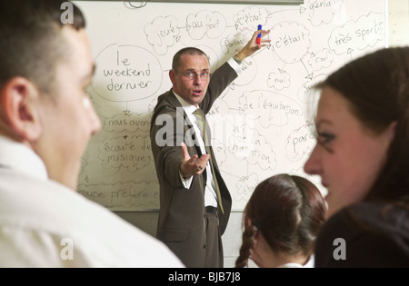 Teacher using 'mind mapping' white board for teaching a Year 11 French language Class at comprehensive school in South Wales UK Stock Photo
