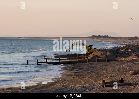 Moving boulders on the beach, tywyn Stock Photo