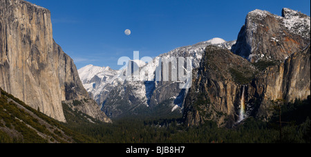 Panorama of Yosemite Valley from Tunnel View with moon and rainbow on Bridalveil Falls with blue sky Yosemite National Park California USA Stock Photo