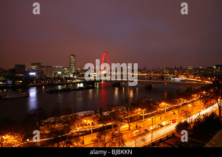 River Thames at dawn looking towards South Bank, London Eye and Westminster, London, UK. Taken from Victoria Embankment. Stock Photo