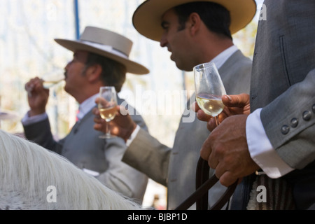 Horsemen drinking sherry, Horse Fair Jerez De La Frontera, Andalucia, Spain Stock Photo