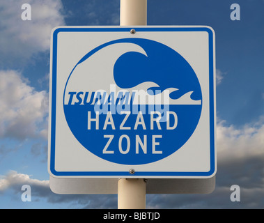 Tsunami warning sign with a cloud filled sky. Stock Photo
