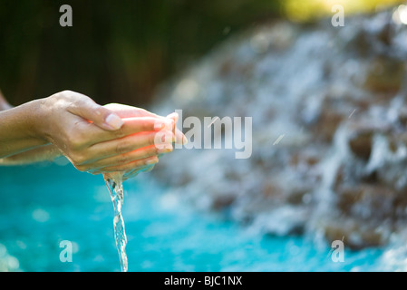 Water flowing from cupped hands Stock Photo